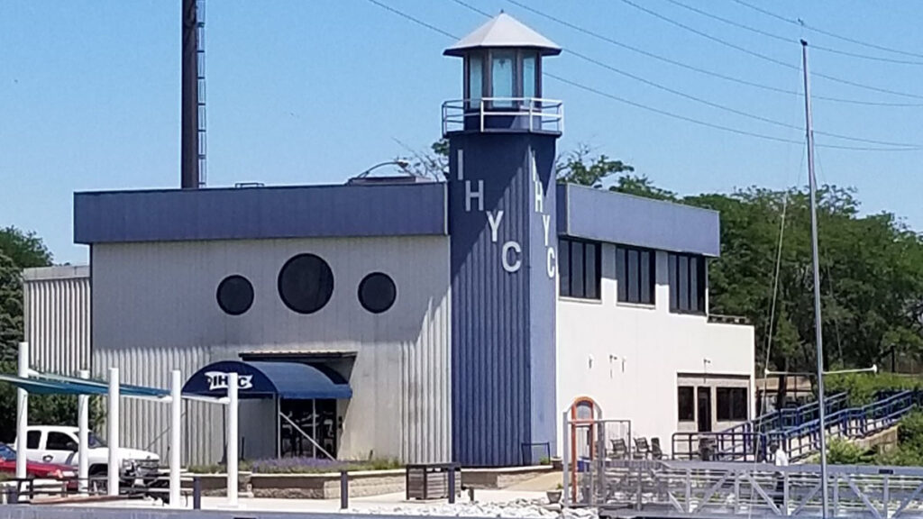 View of the blue and white Indiana Harbor Yacht Club building in East Chicago, Indiana.