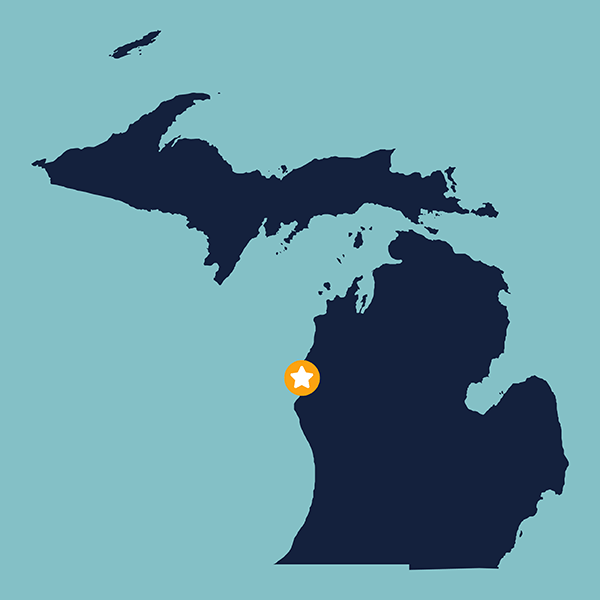 Blue shape of the state of Michigan on a light blue field with a gold and white star representing the Ludington Yacht Club in Ludington, Michigan.