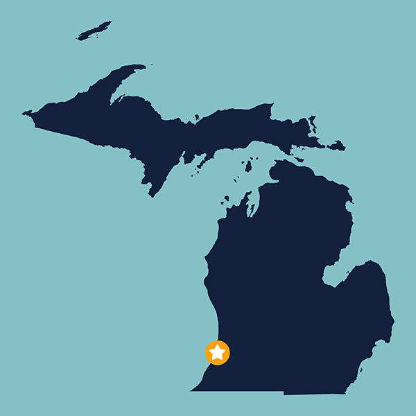 Blue shape of the state of Michigan on a light blue field with a gold and white star representing the St. Joseph River Yacht Club in St. Joseph, Michigan.