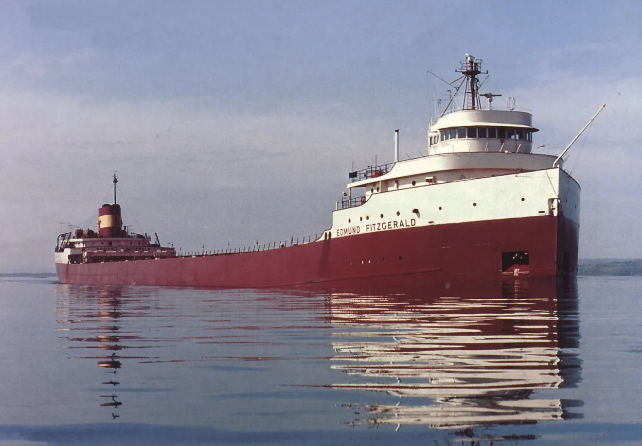The Edmund Fitzgerald ship, a very long red and white ship in the water
